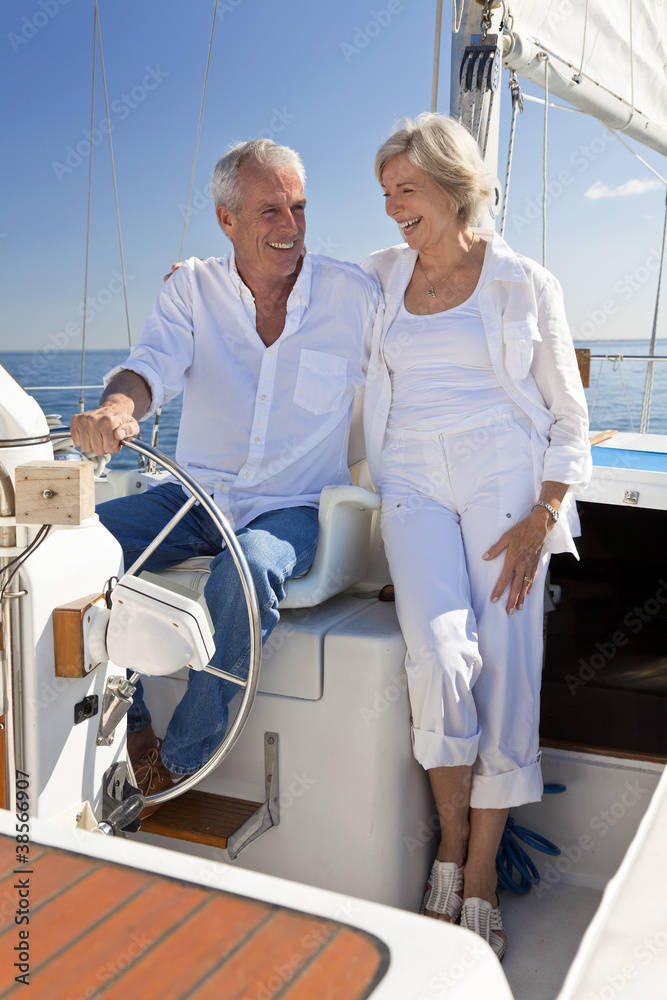 Happy Senior Couple At The Wheel of a Sail Boat Happy Senior Couple At The Wheel of a Sail Boat