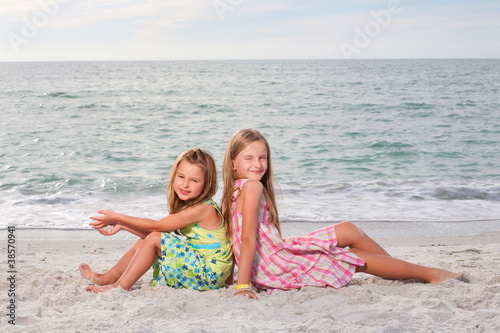 Little girls enjoy summer day at the beach. © Mirma