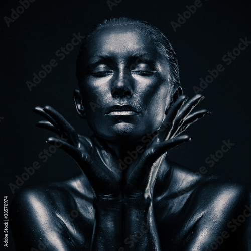 Nude woman like statue in liquid metal