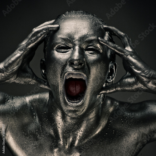Nude woman like statue in liquid metal