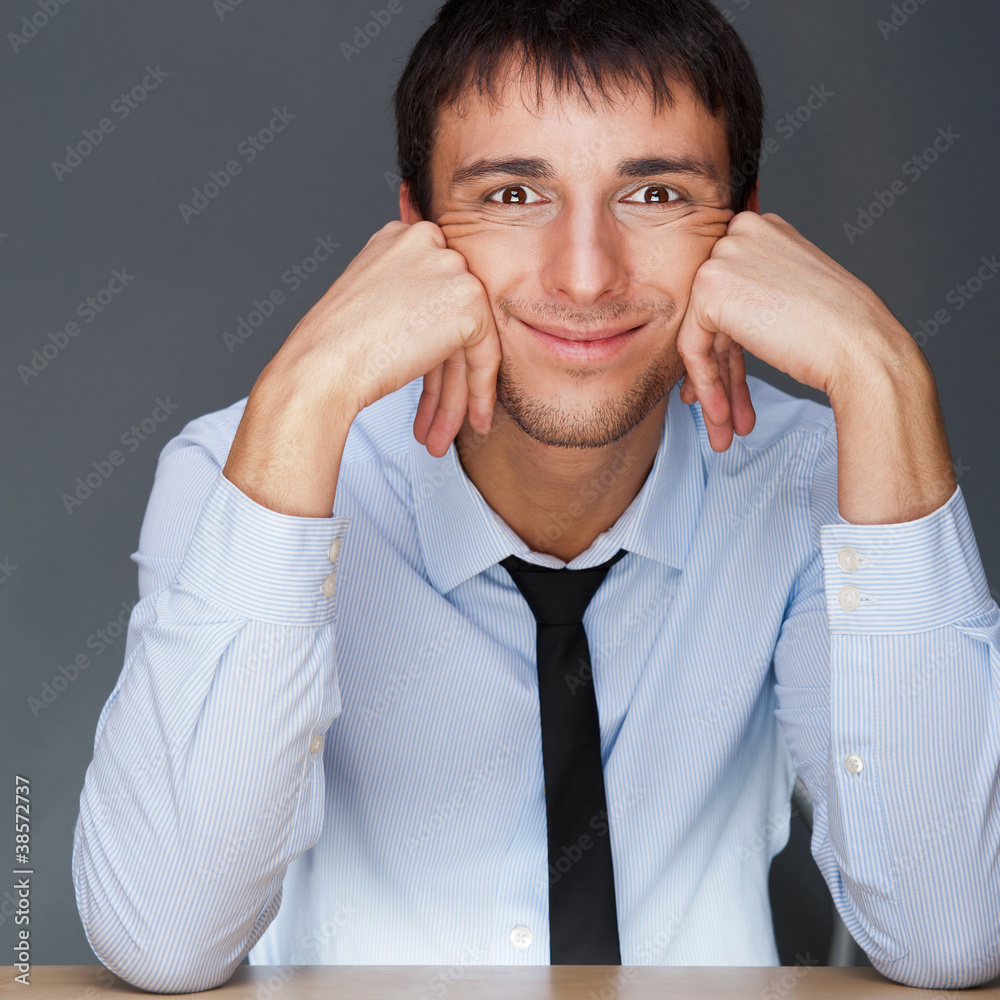 Portrait of young business man on a desk playing the ape Portrait of young business man on a desk playing the ape