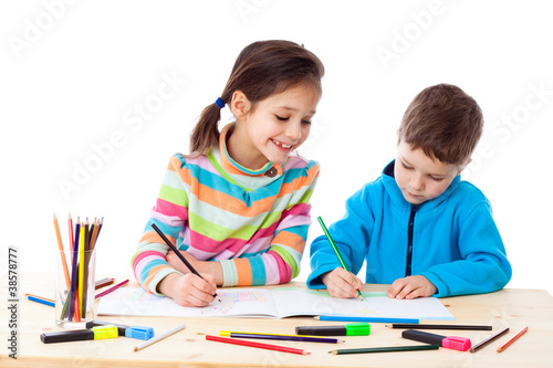 Two little kids draw with crayons