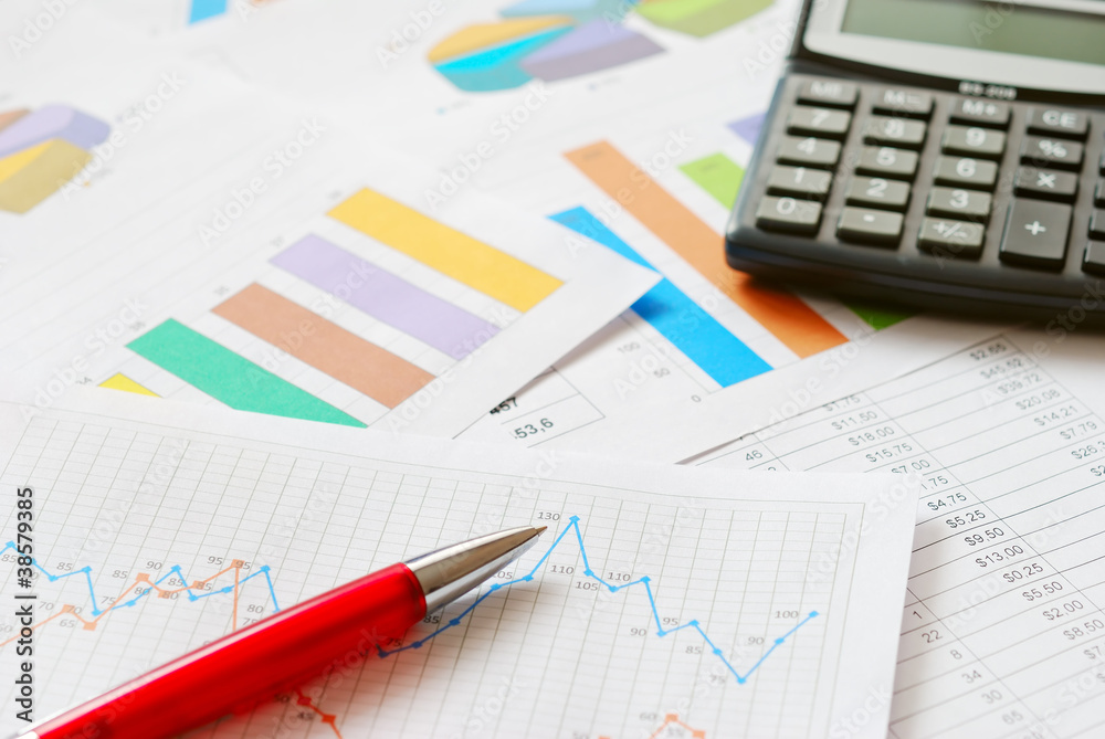 Financial documents with red pen and calculator Financial documents with red pen and calculator