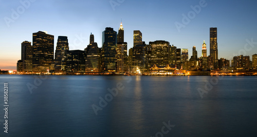 Manhattan skyline at dusk over Hudson River with skyscrapers