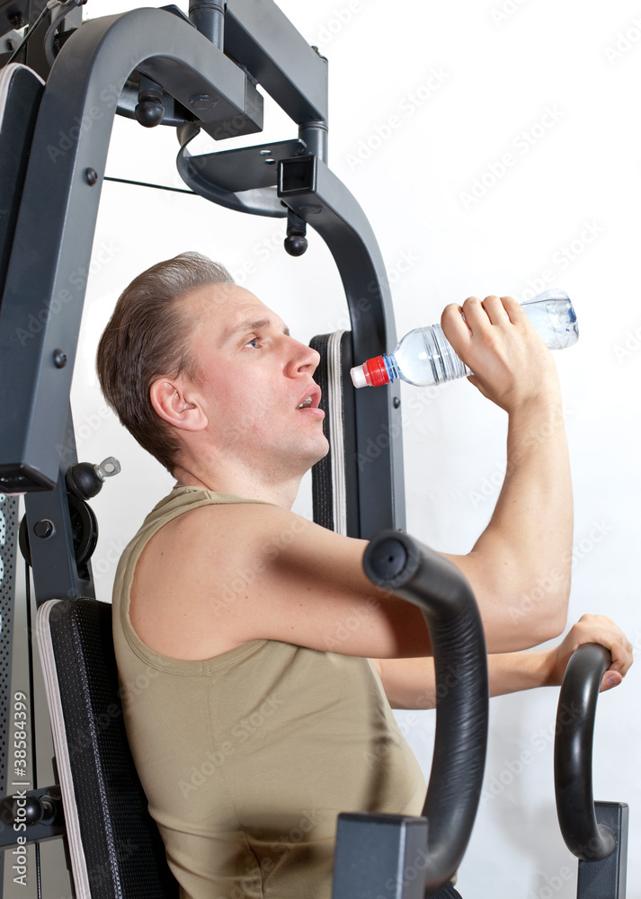 young man drink water at fitness training young man drink water at fitness training
