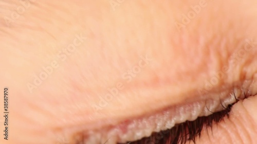 Single eye closeup, eyelid lifts and pupil expands photo