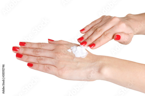 Female hand with manicure applying cream