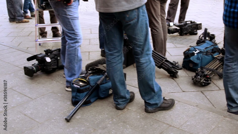Television equipment lay on ground near operators legs Television equipment lay on ground near operators legs