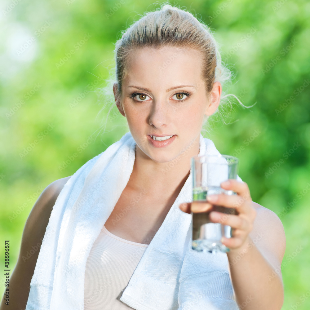 Woman drinking water after exercise Woman drinking water after exercise