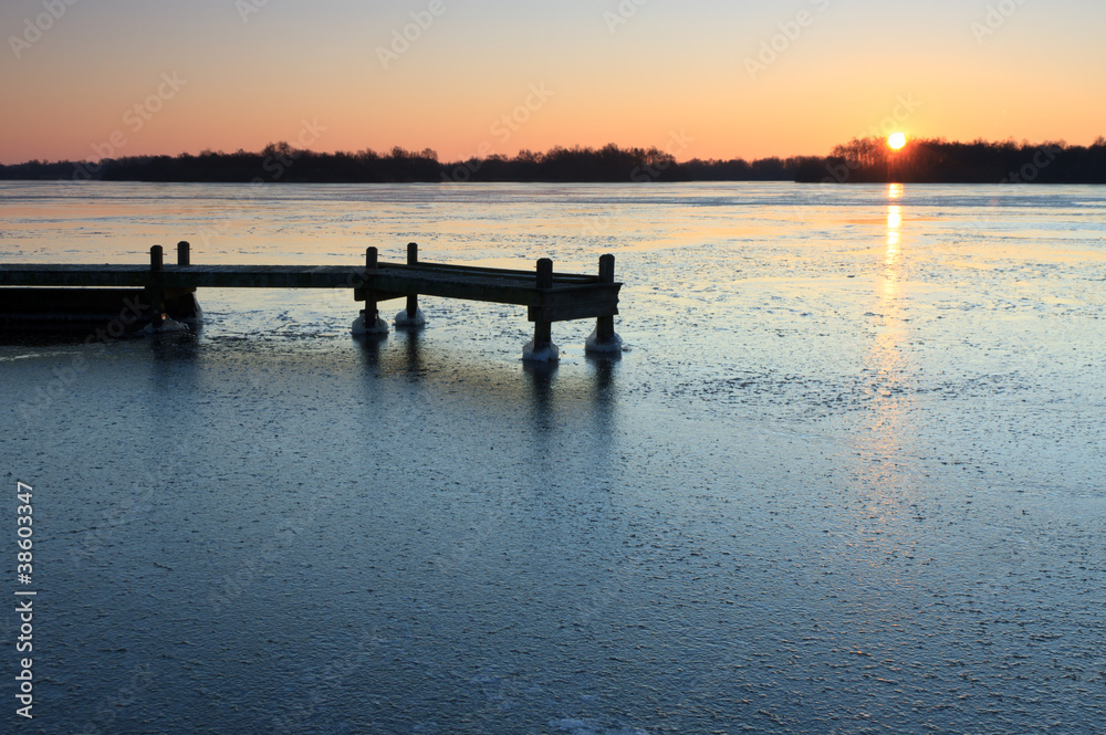 Jetty in the ice of a frozen lake.