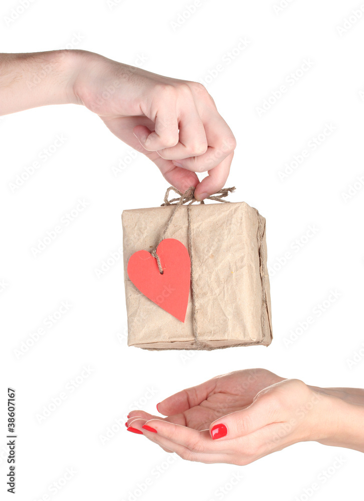 Fototapeta premium Man's hand giving parcel with blank heart-shaped label to woman