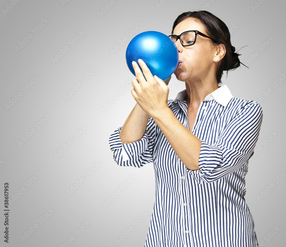 woman blowing balloon woman blowing balloon