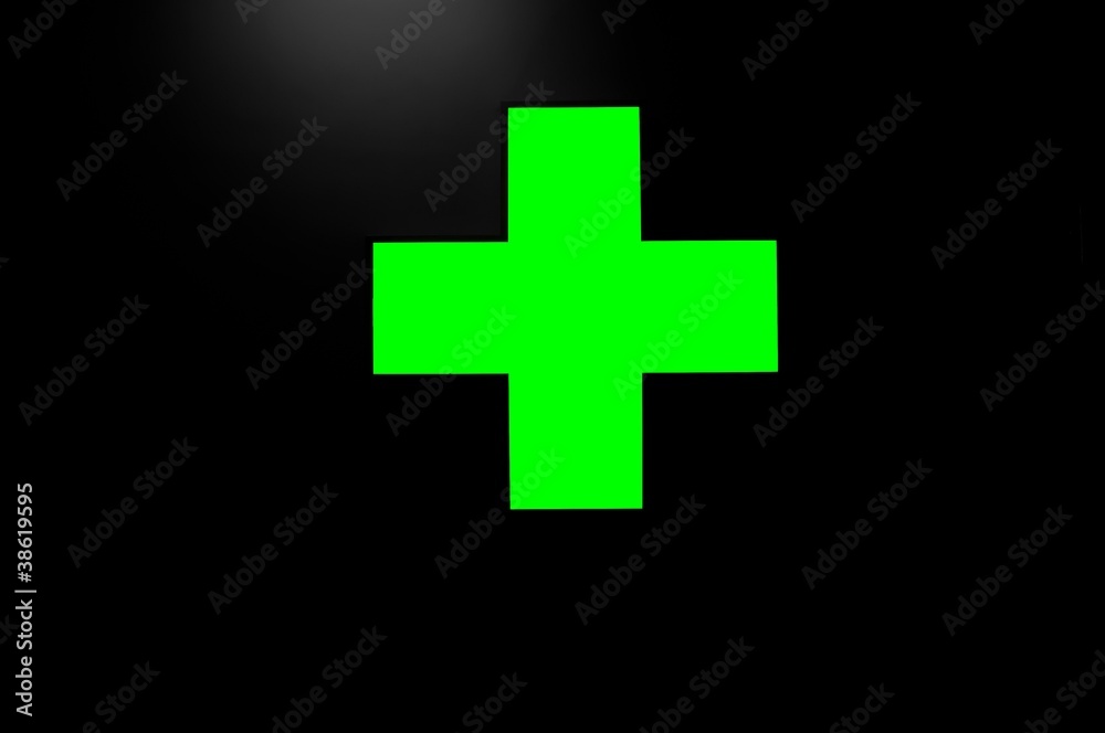 Fototapeta premium Green cross on black background with a little light