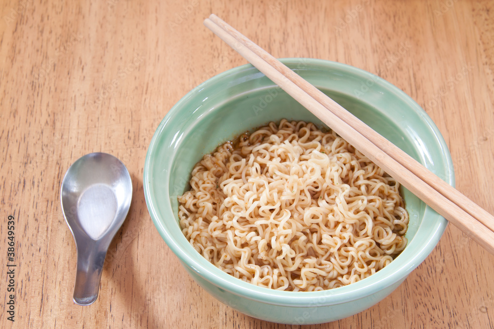 instant noodle with spoon and chopsticks in a ceramic bowl instant noodle with spoon and chopsticks in a ceramic bowl