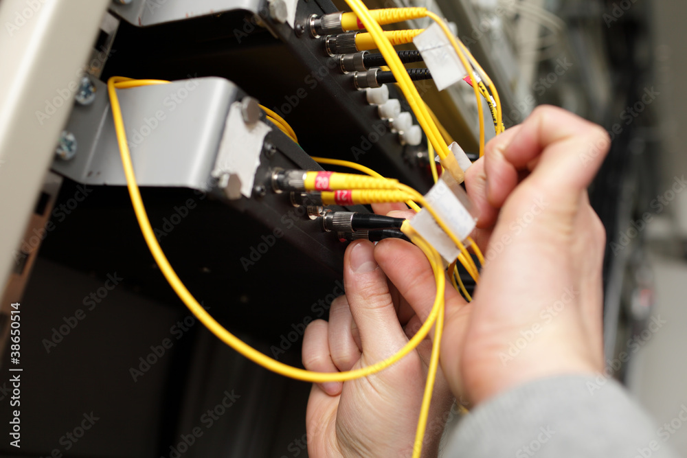 Technician with optical connector Technician with optical connector