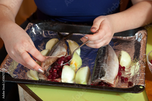 cook making  mackerel with cranberries photo