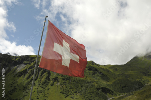 Swiss flag in front of hills around Allmendhubel