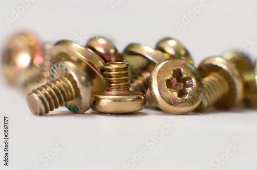Pile of yellow metallic  screws