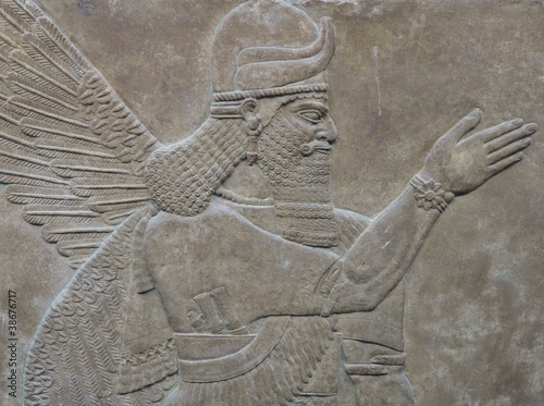 Ancient Assyrian wall carving of a man photo