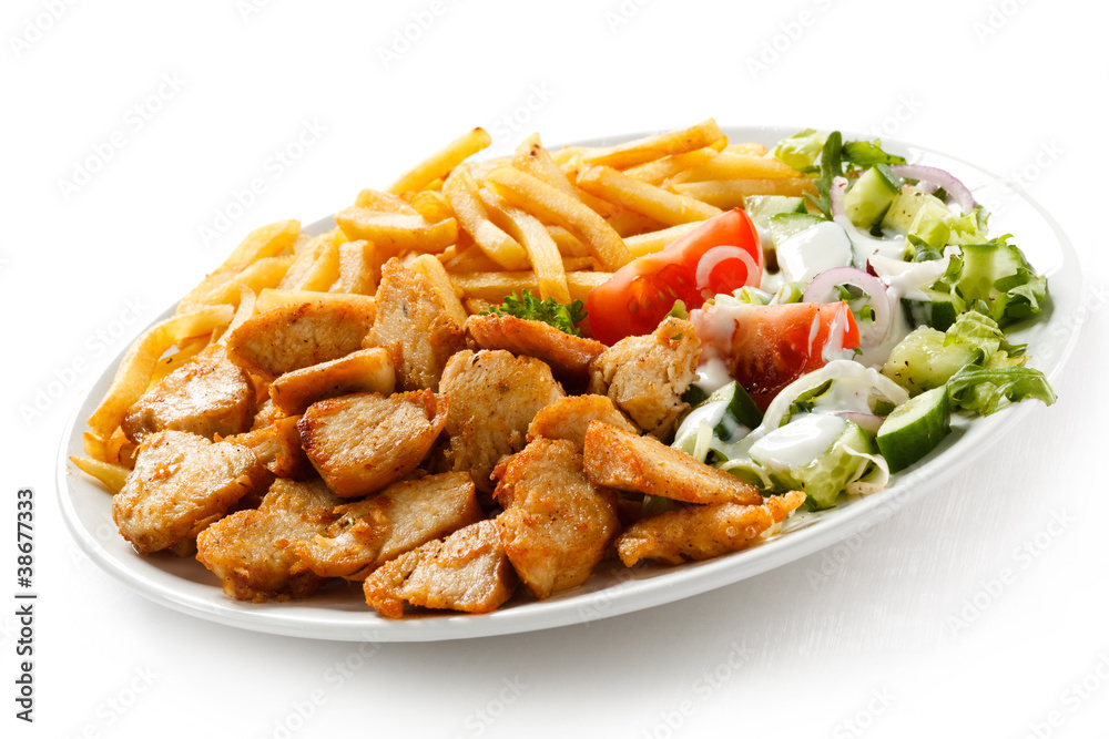 Grilled meat with French fries and vegetables Grilled meat with French fries and vegetables