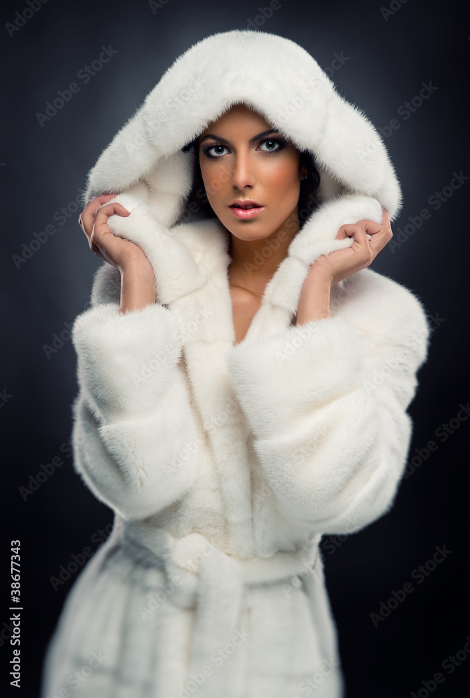 Beautiful woman in white fashionable fur coat Beautiful woman in white fashionable fur coat