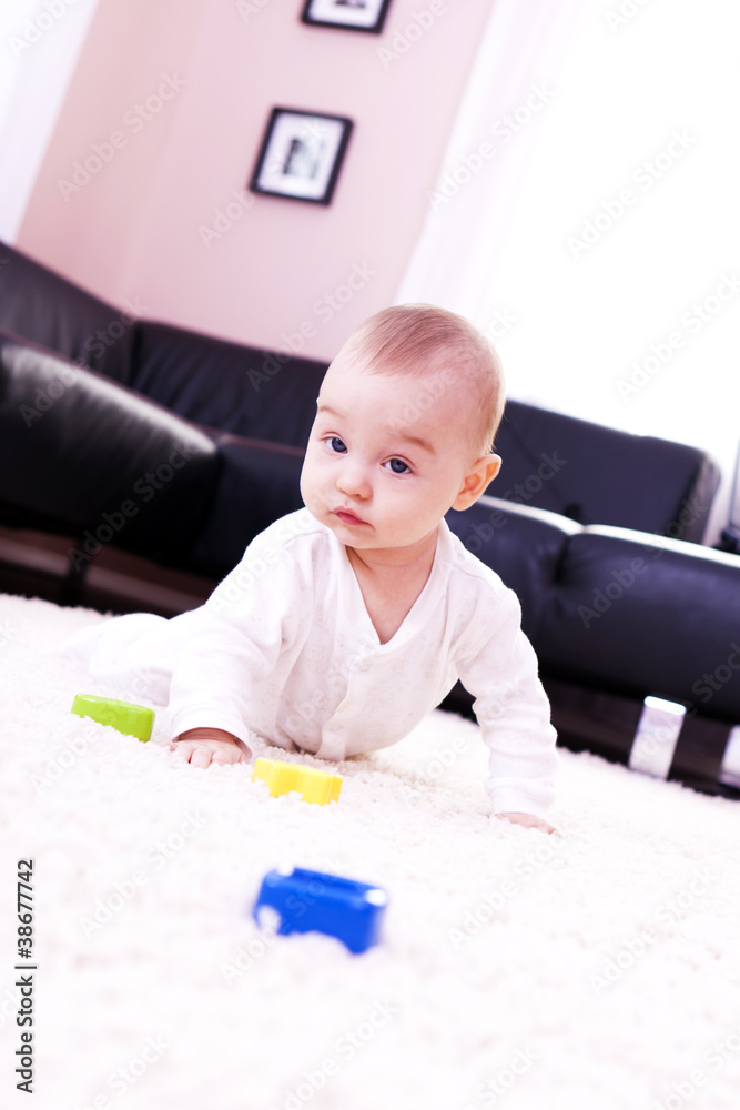 Baby plays in the modern living room. Baby plays in the modern living room.