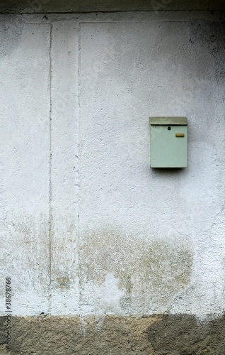 vintage mail box on damaged mortar facade
