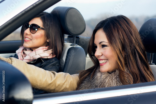 two girls in a convertible car © nenetus