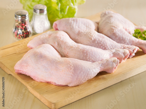 Fresh raw chicken legs arrangement on kitchen board