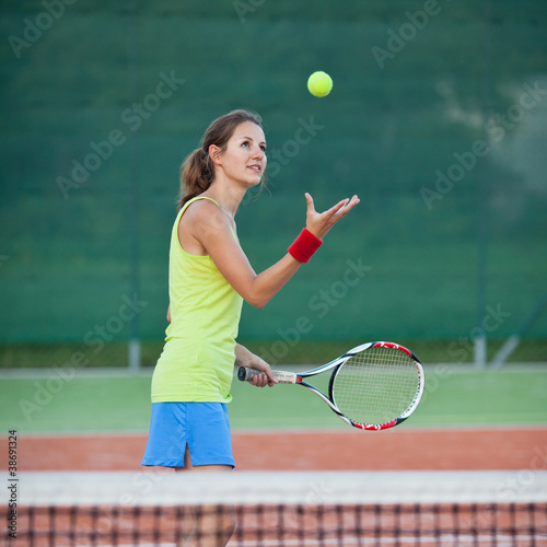 pretty, young female tennis player on the tennis court © lightpoet