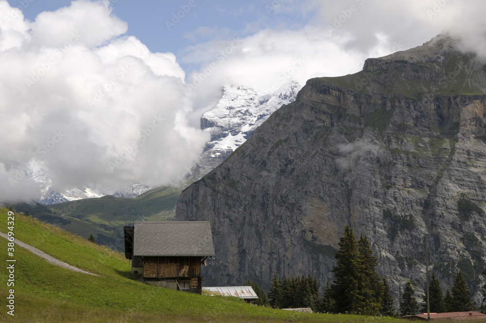 Schwarzmonch rockface of Jungfrau mountain above Swiss farm Schwarzmonch rockface of Jungfrau mountain above Swiss farm