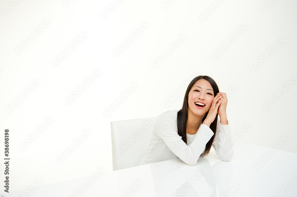 attractive asian woman sitting in white room attractive asian woman sitting in white room
