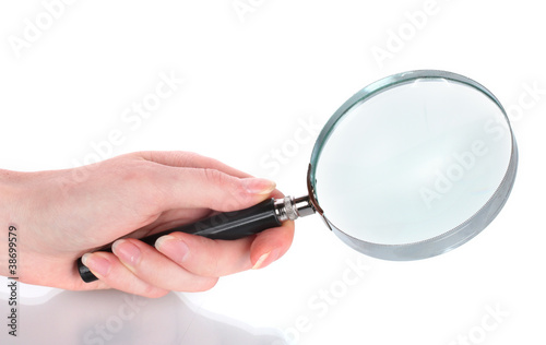 Magnifying glass in hand isolated on white