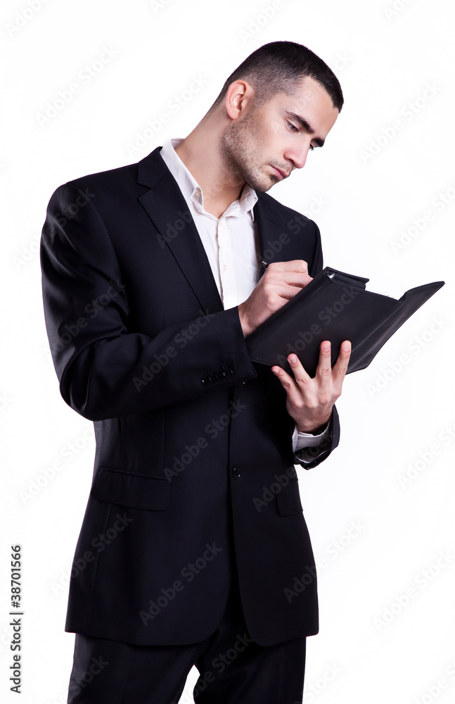 Elegant young business man writing in a notebook Elegant young business man writing in a notebook