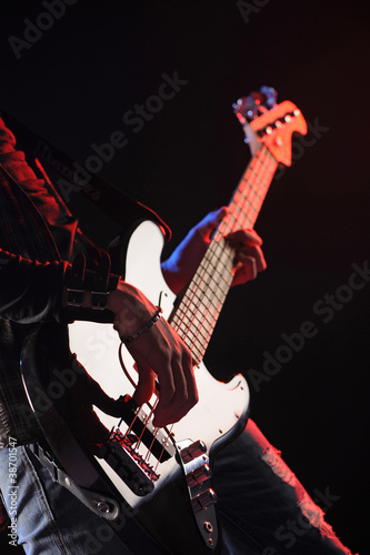 close up of hands playing an bass
