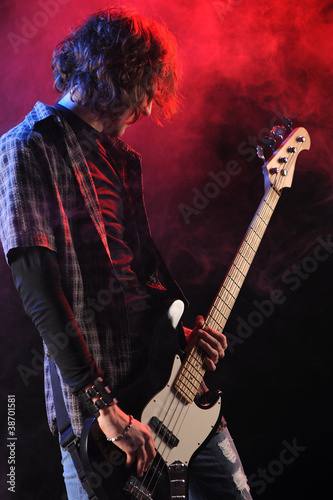 a bassist plays at a live concert photo