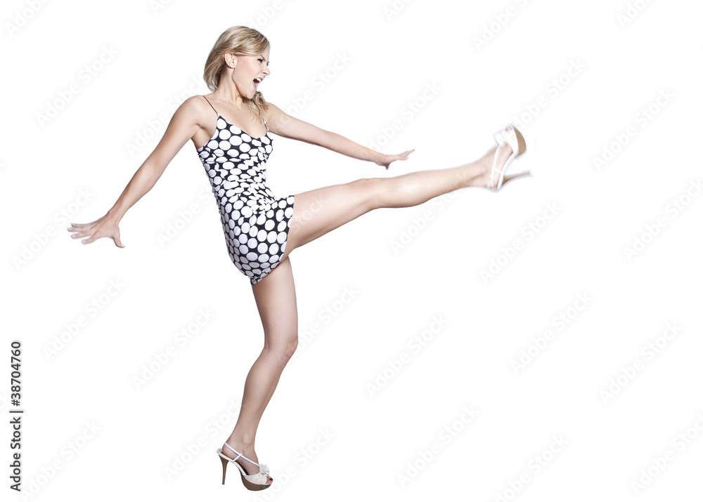 beautiful blonde woman kicking, isolated on a white background