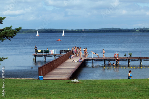 Pier on lake,sailing boats and forest. Masurian Lakes District