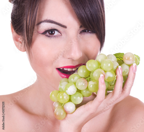 Beautiful young woman with green grape