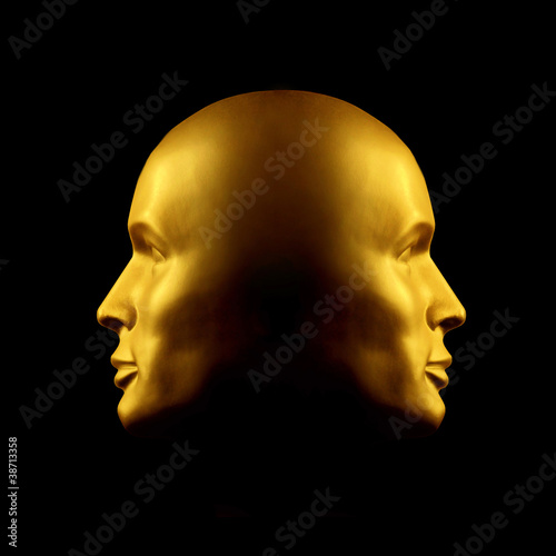 Two-faced gold head statue photo