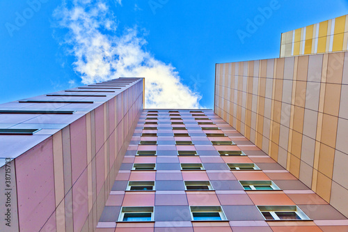 facade of skyscraper with apartments with blue sky photo