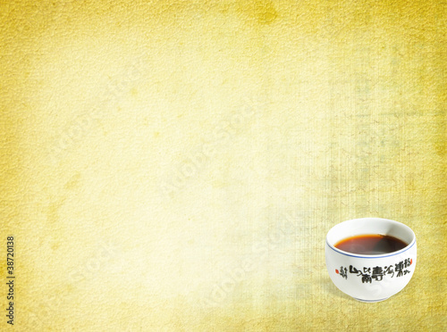 China teacup at old textured paper background