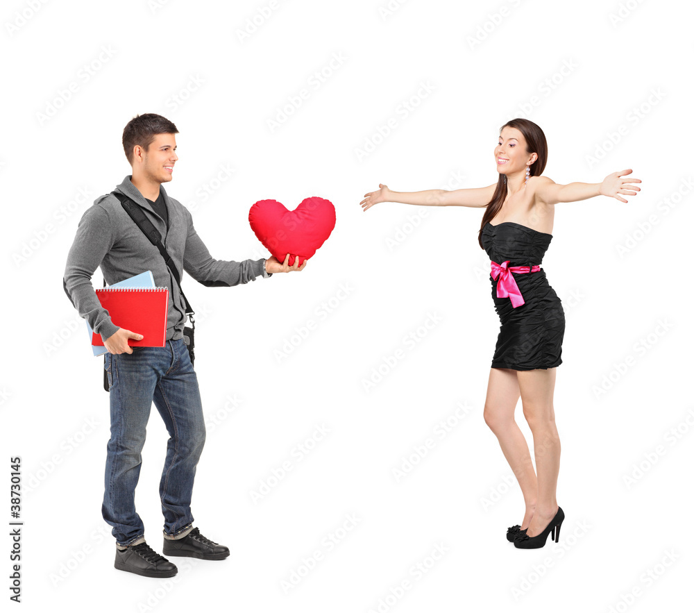 Boy holding a red heart shaped pillow in his hand and an excited Boy holding a red heart shaped pillow in his hand and an excited