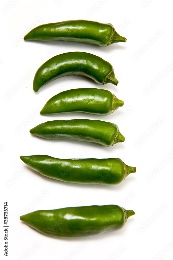 Green chilli peppers isolated on a white studio background. Green chilli peppers isolated on a white studio background.
