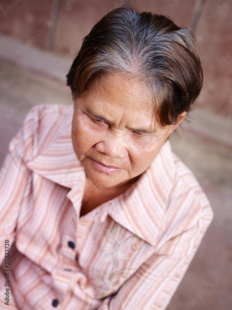 Portrait of old asian woman looking at camera