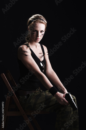 Shot of a sexy military woman posing with gun