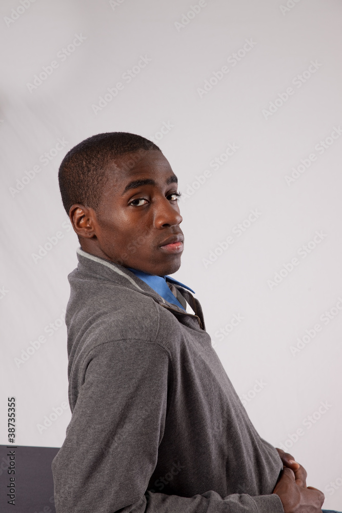 Handsome black man in sweater and tie with eye contact