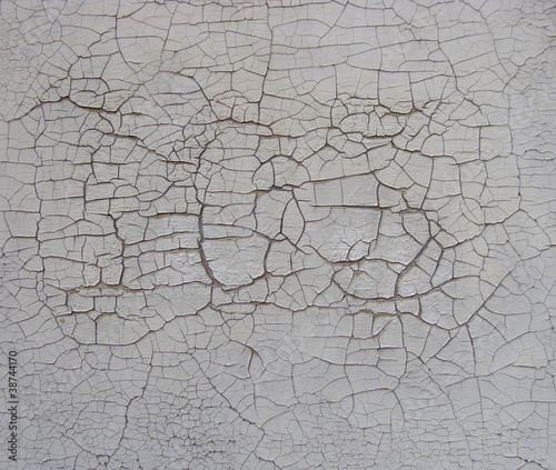 subtle cracked paint pattern on white wall