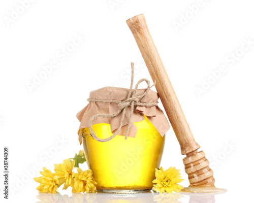 Jar of honey and wooden drizzler isolated on white