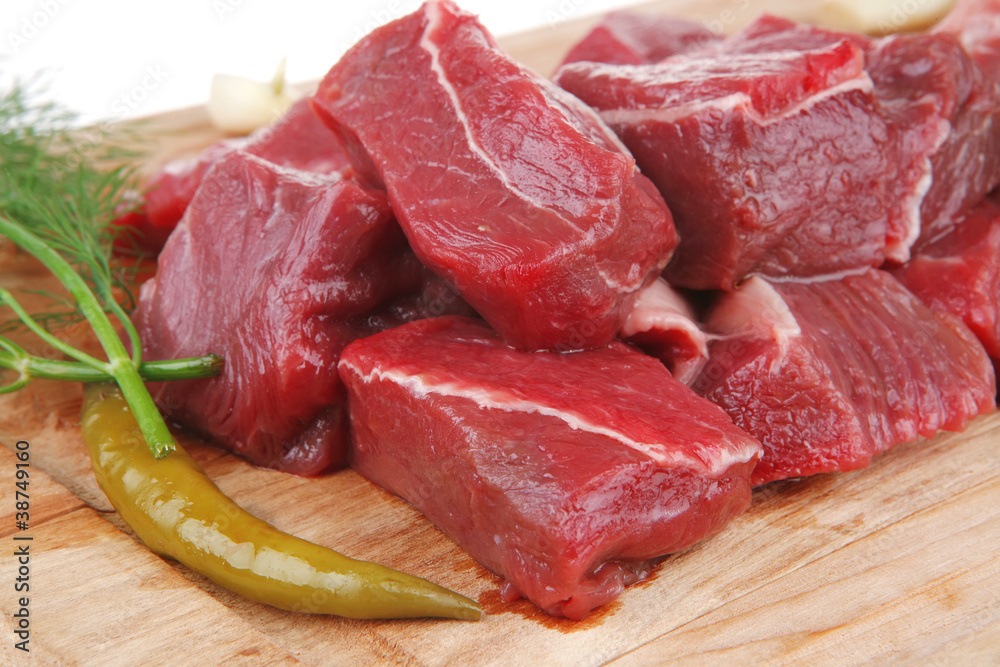 beef meat slices over a wooden board